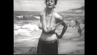 Playful lady with big melons takes off her Hawaiian outfit and shows her round ass on the beach