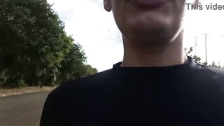 A hot older woman giving a blowjob to a pedestrian in the middle of the street during the day.