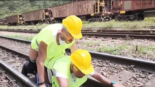 The workers were doing maintenance on a railway line, and the work was hard with a passive colleague in the middle of the tracks.
